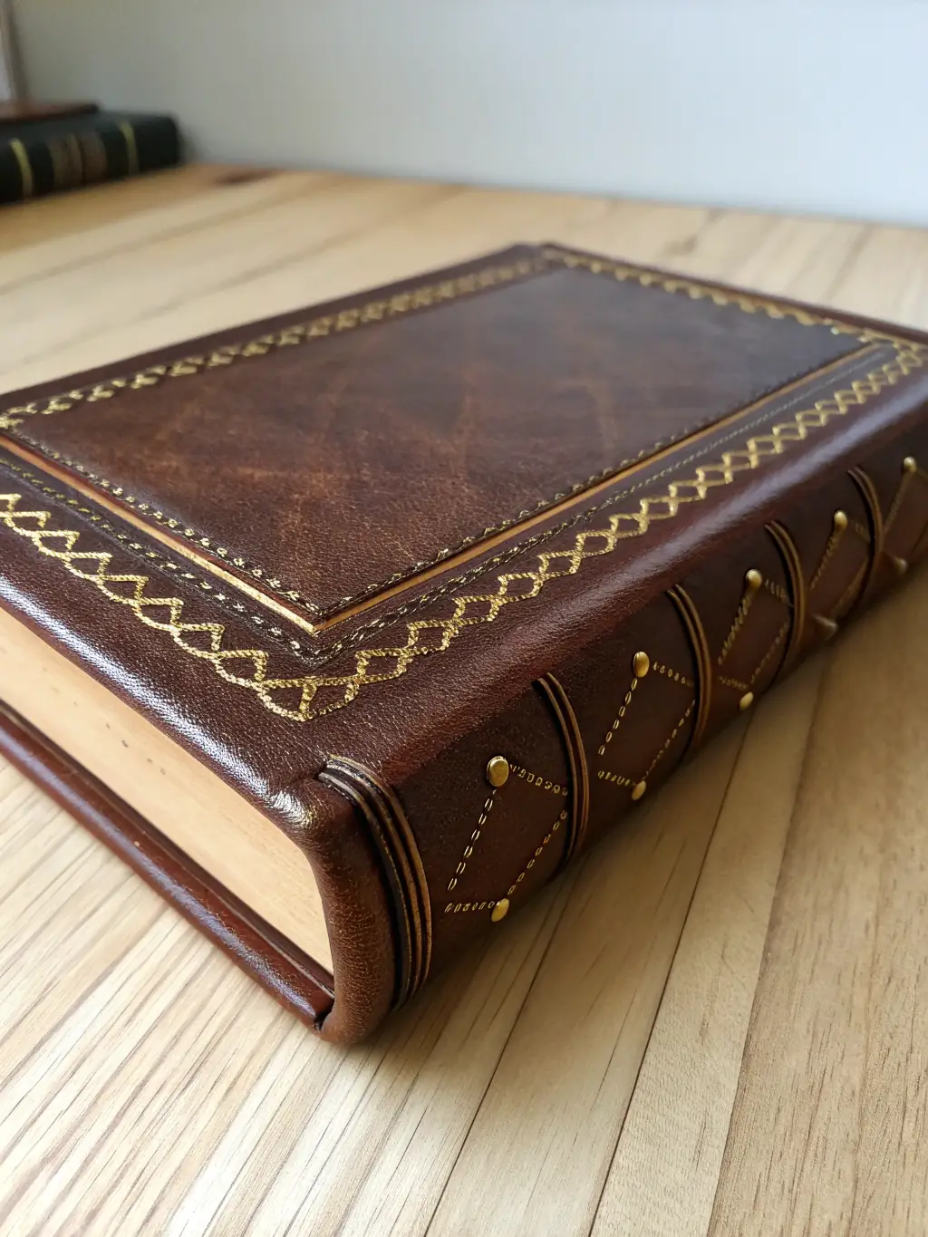 A close-up shot of a first edition of a classic French novel, showcasing its aged cover, gold leaf lettering, and intricate binding, displayed in a protective case.